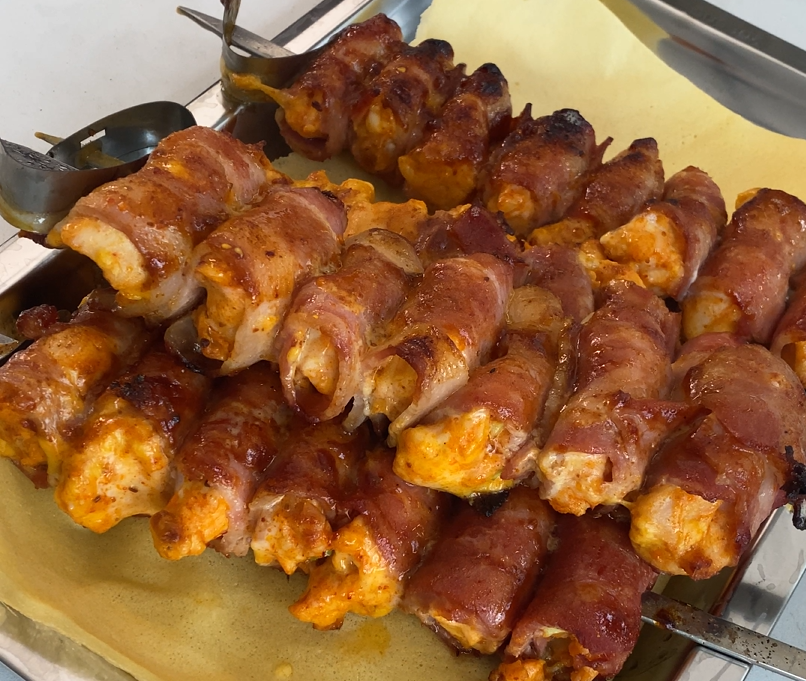 well cooked bacon wrapped chicken skewers