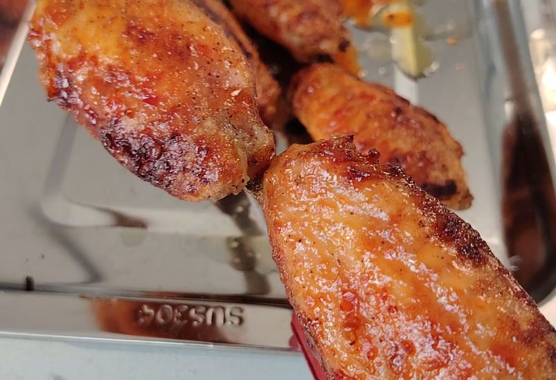 well cooked chicken wings on skewers by yanflamma smokeless grill